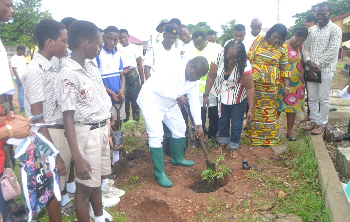 Mr Nikoi ( middle) planting a tree at Tenashie JHS. With him are other directors and dignitaries Photo Victor A Buxton
