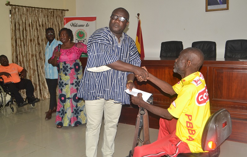 Mr Solomon Nikoi Kotey (second from right) presenting a cheque to a beneficiary Photo Victor A. Buxton
