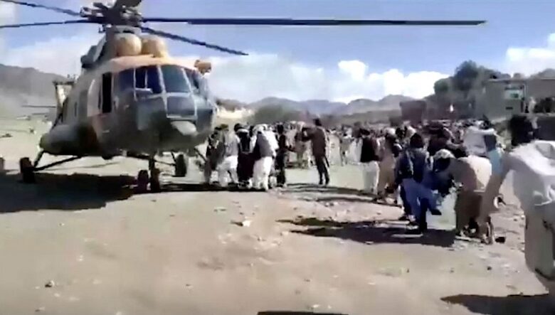 People injured in the earthquake are rushed to a rescue helicopter
