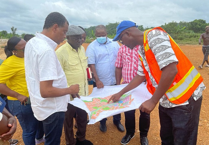 Mr Owusu-Bio (second from left) interacting with other members of the Committee and workers at the site