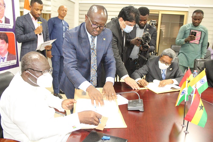 Mr Ken Ofori-Atta (left) and Mr Selver Kumar signing the documents. Photo. Ebo Gorman