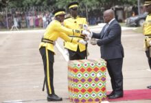 President Akufo-Addo (right) presenting a stuff to Homey Matthew Amegbor the overall best officer cadet