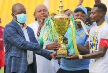 • FA President Kurt Okraku (left) presents the trophy to Rences FC captain while FA ExCo member Samuel Anim Addo and GARFA boss Samuel Aboabire look on Photo: Raymond Ackumey