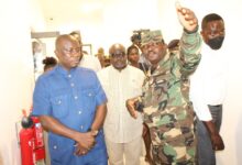 • Inset: Mr Dominic Nitiwul (left) being briefed the progress of work during his visit to the CDS newly office block by Lt. Col. Tekyi (hand raised). Photo: Ebo Gorman
