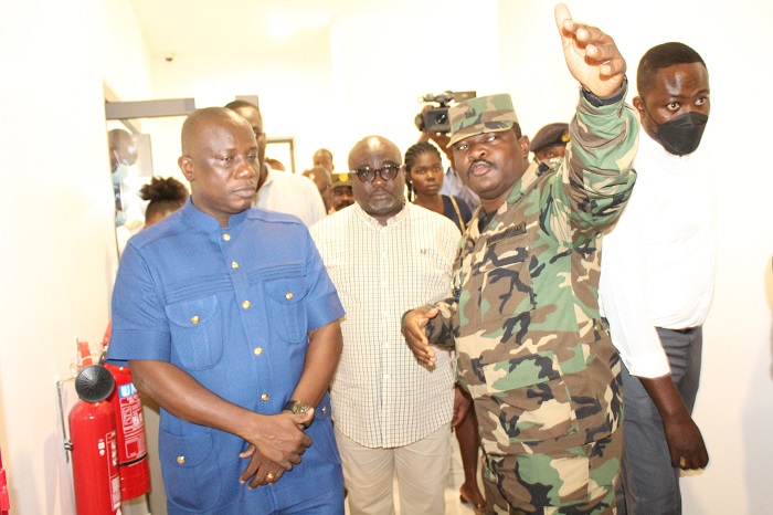 • Inset: Mr Dominic Nitiwul (left) being briefed the progress of work during his visit to the CDS newly office block by Lt. Col. Tekyi (hand raised). Photo: Ebo Gorman