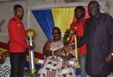 • Gbese Mantse receives the trophy from the Mr Odotei Sowah (right) skipper of the side Fatawu Mohammed and goalkeeper Ben Mensah
