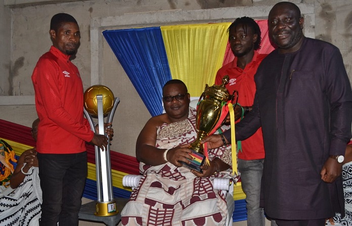 • Gbese Mantse receives the trophy from the Mr Odotei Sowah (right) skipper of the side Fatawu Mohammed and goalkeeper Ben Mensah