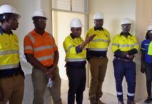 • Inset: Mr Adama (third from left) conducting journalists round the project site