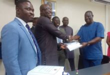 • Mr Amoako–Atta (Second Right) exchanging the signed documents with Mr Eric Seddy Kutortse, Chairman of First Sky