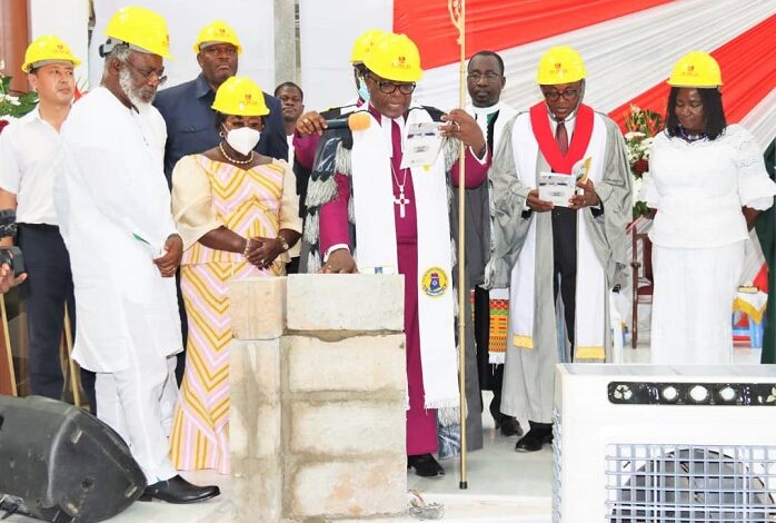 Most Rev. Dr Boafo (middle), Mrs Opare (next to him), Mr Quartey (behind her) with other officials saying a prayer after laying the stone