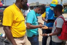 • MTN staff checking registration status and registering customers who needs to register their SIM cards at Kaneshie Market 2