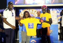 • Mr Sahnoon (left) and Linda Panin from Promasidor Ghana present the yellow jersey to Boafo