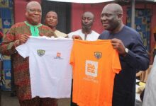• Nii Adam Sorsey (left) and Mr Ototei with some of the T-shirts