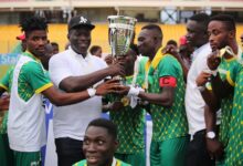 • Nsoatreman FC players presenting the trophy to Mr Baffour Awuah after their coronation