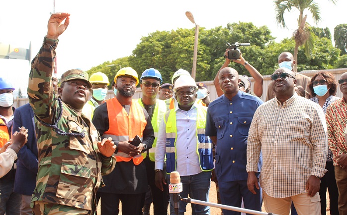 Lt. Col.Tekyi (hand raised) briefing Mr Dominic Nitiwul and his entourage the progress of work during his visit to the ongoing Army Headquarters office block. Photo. Ebo Gorman