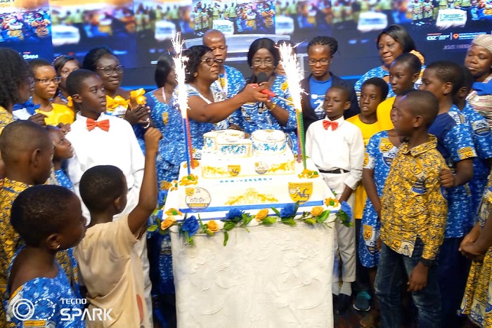 Reverend Mrs Comfort Wilson, Lady Pastor of the Holy Hill Assemblies of God cutting the anniversary cake. With her are other lady members and some of the children