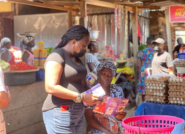 • Mrs Eunice Nyarko educating a market woman