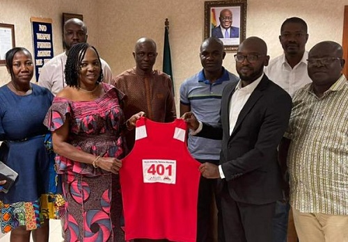 • Madam Sackey, supported by other officials, poses with her vest