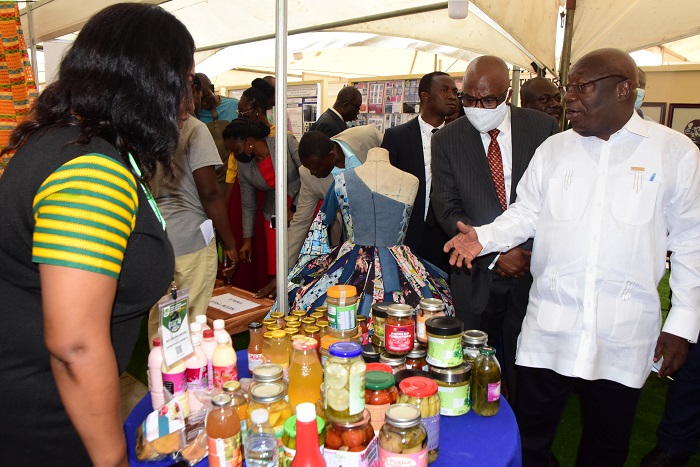 Dr Kwaku Afriyi (right) inspecting somes items on exhibition