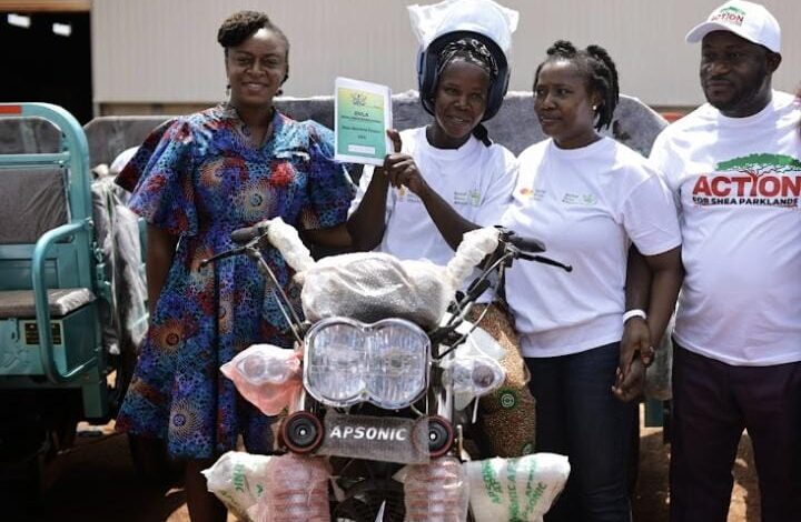 • Rosy Fynn (left), and Aaron Adu (right), president of CSA, presenting tricycles to the shea collectors at the launch