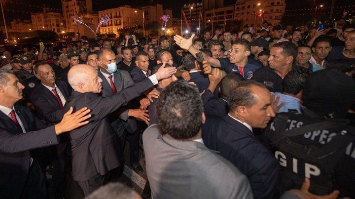 President Saied celebrates with his supporters after Monday's vote