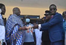 • Inset; Mr Darko-Mensah (right) receiving the keys to the new Police Station from Nana Kwamina Dekye