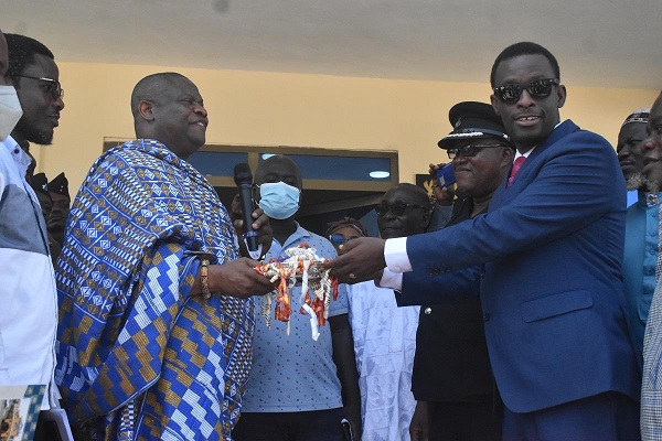 • Inset; Mr Darko-Mensah (right) receiving the keys to the new Police Station from Nana Kwamina Dekye