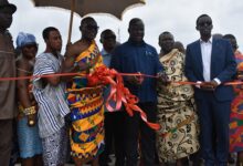 Inset; Mr. Jinapor (third from right) assisted by Mr Darko-Mensah (right), Nana Kwesi Agyeman IX (second from right) and Obrempon Hima Dekyi X1V jointly cutting the tape to open the facility