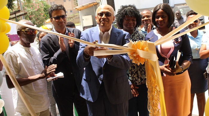 • Mr Lal Gokaldas (middle) cutting the tape to open the facility. Applauding are some staff of Gokals Limited Photo: Ebo Gorman