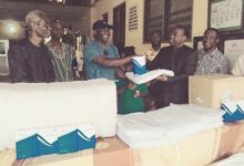 • Mr Stephen Agbo (third from left) presenting the items to Pastor Dr Arloo some of the hospital staff look on