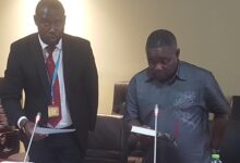 Mr Obiri-Yeboah, right, taking the oath before testifying