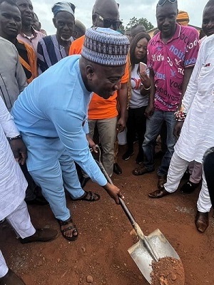 Mr Ibrahim Murtala Mohammed cutting sod for the start of the project