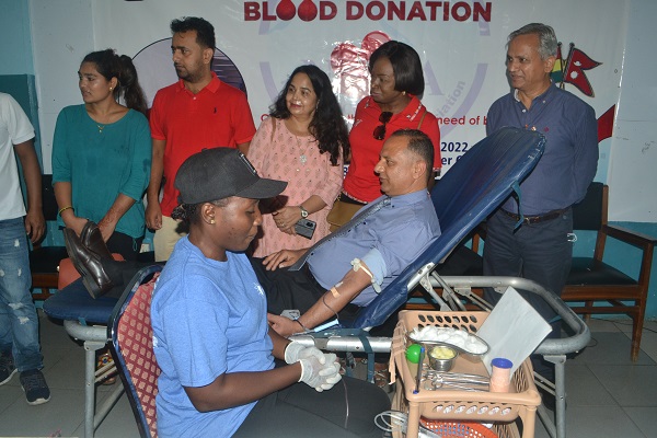 Mr Mainali (on bed) donating blood. With him is Dr Owusu-Ofori (second from right) Photo Victor A. Buxton