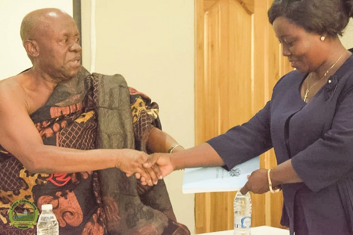 • Ms Abrafi (right) presenting a copy of the Land Act to Ogyeahoho Yaw Gyebi