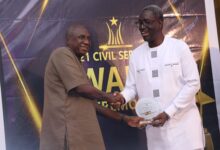 • Mr Dery (left), receiving the award from Nana Agyekum-Dwamena
