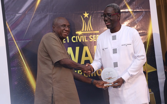 • Mr Dery (left), receiving the award from Nana Agyekum-Dwamena