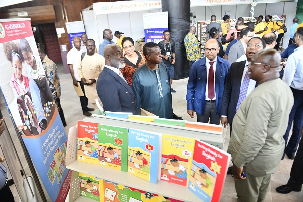 • Mr Edward Yaw Udzu (left), Director of ALLBOOOKS Ltd with Mr Irchad Razaaly (third from right), Mr Abdourahamane Diallo (second from left) and Mr Asare Konadu Yamoah at the one of the exhibition stands Photo: Geoffrey Buta