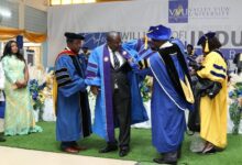 Prof. William Kofi Koomson (second from left) being robbed at the induction ceremony