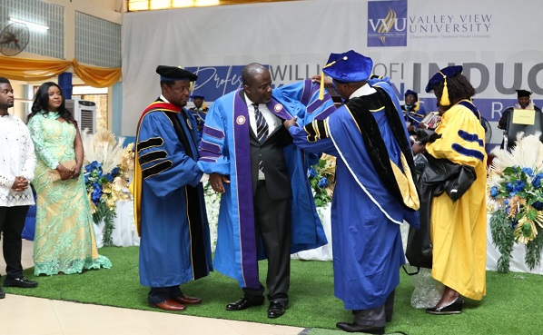 Prof. William Kofi Koomson (second from left) being robbed at the induction ceremony