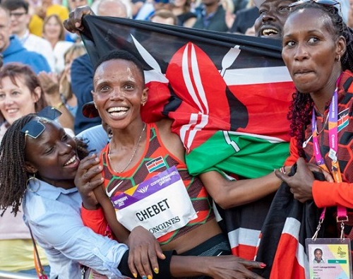 • Chebet - (centre) in cloud nine after winning race