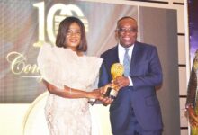 • Mr Kwesi Agyemang Busia, CEO of DVLA (right)receiving his award from Dr Irene Stella Agyenim-Boateng
