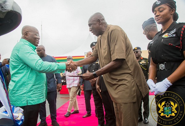 Inset. President Akufo-Addo (left) exhanging greetings with Mr Ambrose Dery after presenting the keys to the motocycles