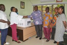 • Madam Sowah (second from left) presenting a printer to Mr Afriyie. With them is Mrs Ashong Photo: Victor A. Buxton