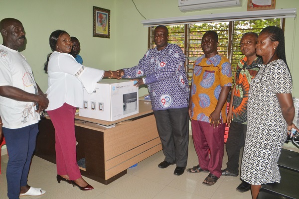 • Madam Sowah (second from left) presenting a printer to Mr Afriyie. With them is Mrs Ashong Photo: Victor A. Buxton