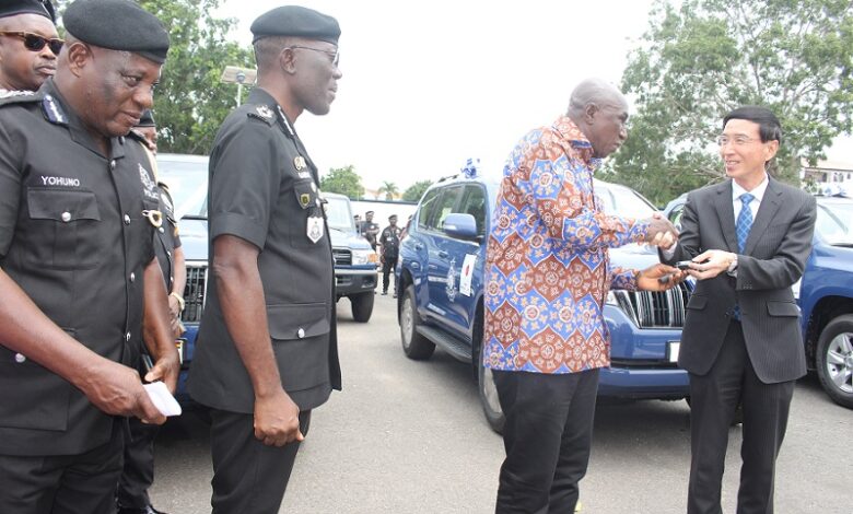• Mr Hisanobu Mochizuki (right) presenting the keys to the vehicles to Mr Ambrose Dery, (third from left). With them are Dr Dampare and members of the police management board Photo Anita Nyarko-Yirenkyi