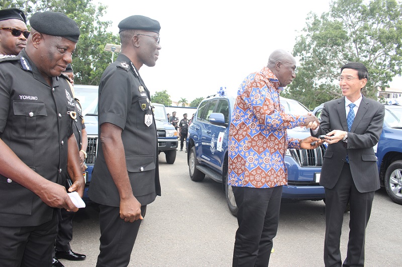 • Mr Hisanobu Mochizuki (right) presenting the keys to the vehicles to Mr Ambrose Dery, (third from left). With them are Dr Dampare and members of the police management board Photo Anita Nyarko-Yirenkyi