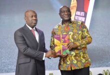 Mr Kojo Oppong Nkrumah (left) and Mr Alan Kyerematen displaying the book during the inaugural session