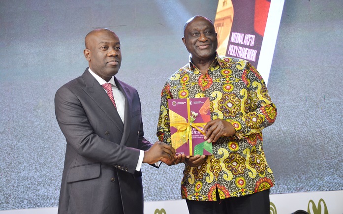 Mr Kojo Oppong Nkrumah (left) and Mr Alan Kyerematen displaying the book during the inaugural session