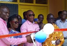 Mr Duker ( middle) assisted by Dr Eduah ( left) and Nana Minnah (rt) to inaugurate the Teberebe M/A Basic school