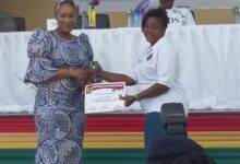 Mrs Bawumia (left) presenting a certificate to a beneficiary